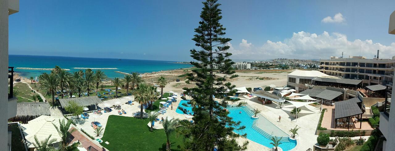 Venus Beach Hotel Paphos Exterior photo A view of the beach at the Nissi Beach Hotel