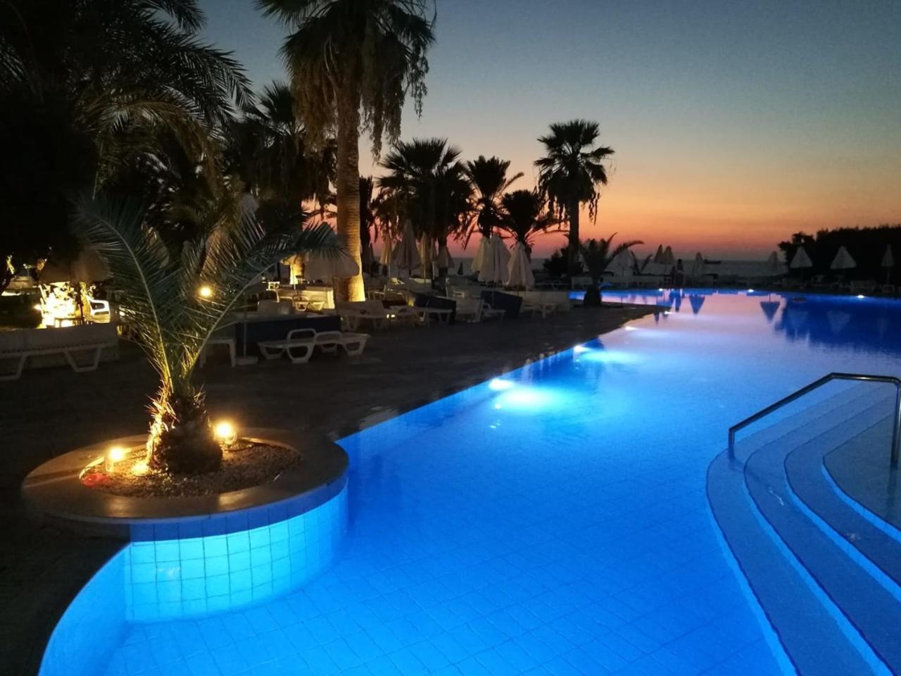 Venus Beach Hotel Paphos Exterior photo Sunset at the pool of the hotel