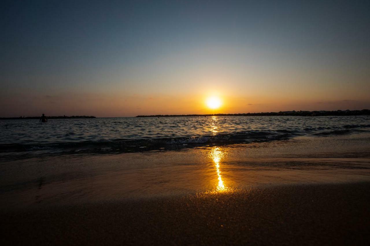 Venus Beach Hotel Paphos Exterior photo Sunset at the beach